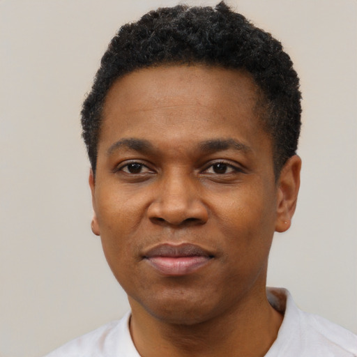 Joyful black young-adult male with short  black hair and brown eyes