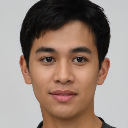 Joyful asian young-adult male with short  black hair and brown eyes