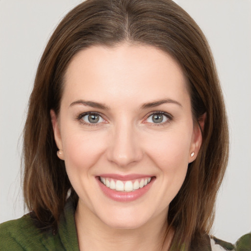 Joyful white young-adult female with long  brown hair and green eyes