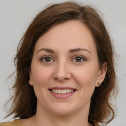 Joyful white young-adult female with medium  brown hair and green eyes