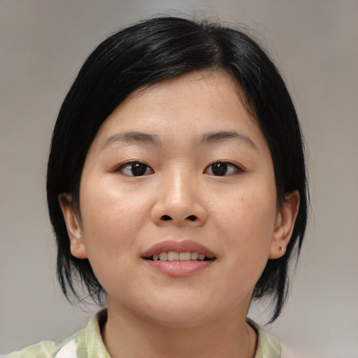 Joyful asian young-adult female with medium  black hair and brown eyes