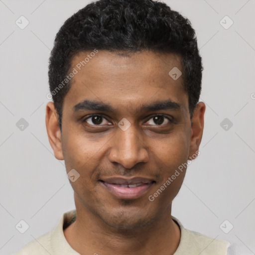 Joyful black young-adult male with short  black hair and brown eyes