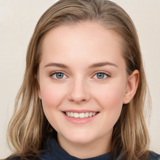 Joyful white young-adult female with medium  brown hair and blue eyes