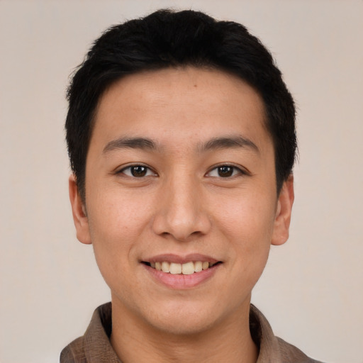 Joyful asian young-adult male with short  black hair and brown eyes