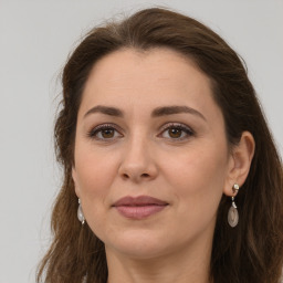 Joyful white adult female with long  brown hair and brown eyes