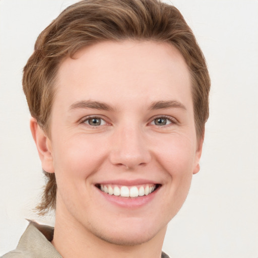 Joyful white young-adult female with short  brown hair and grey eyes