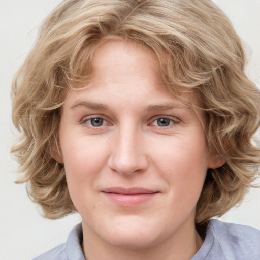 Joyful white young-adult female with medium  brown hair and blue eyes