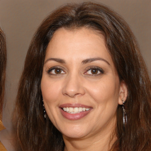 Joyful white adult female with medium  brown hair and brown eyes