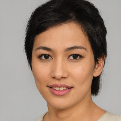 Joyful asian young-adult female with short  brown hair and brown eyes