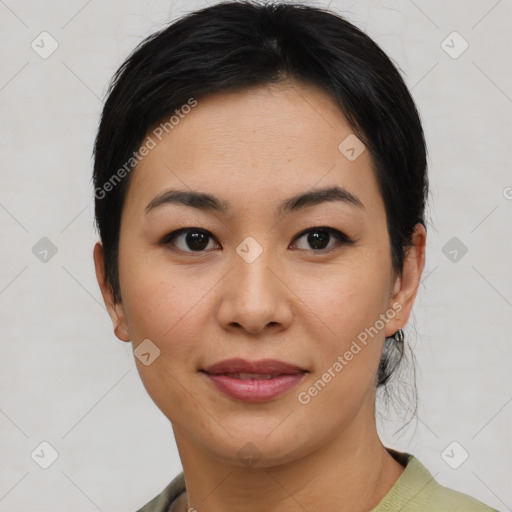 Joyful asian young-adult female with short  black hair and brown eyes