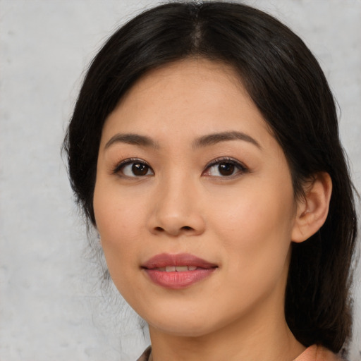 Joyful latino young-adult female with medium  black hair and brown eyes