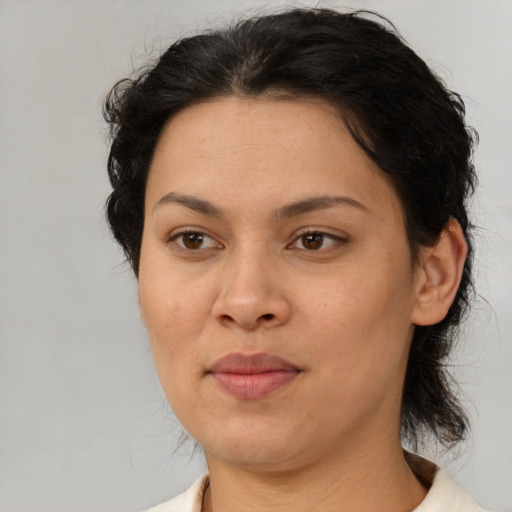Joyful latino adult female with medium  brown hair and brown eyes