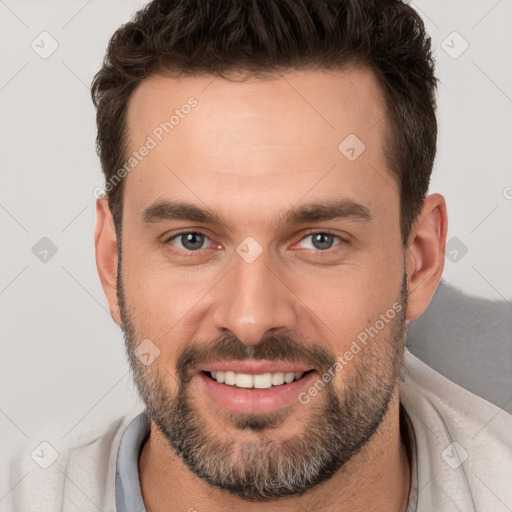 Joyful white young-adult male with short  brown hair and brown eyes