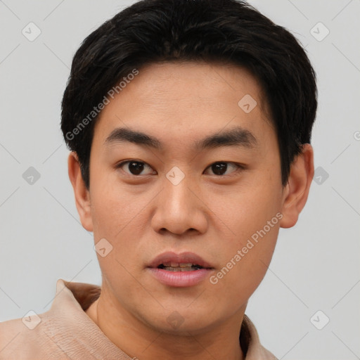 Joyful asian young-adult male with short  black hair and brown eyes