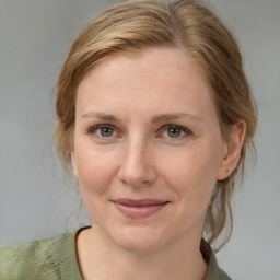 Joyful white adult female with medium  brown hair and grey eyes