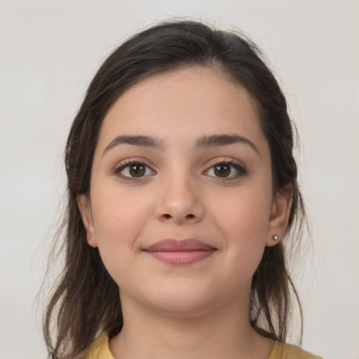 Joyful white young-adult female with medium  brown hair and brown eyes