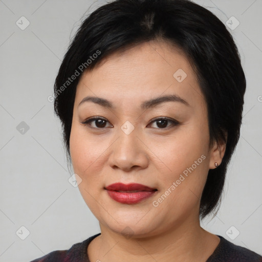 Joyful asian young-adult female with medium  black hair and brown eyes