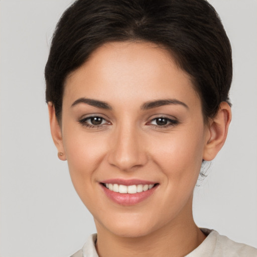 Joyful white young-adult female with short  brown hair and brown eyes