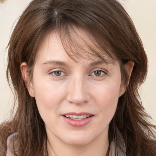 Joyful white adult female with long  brown hair and brown eyes