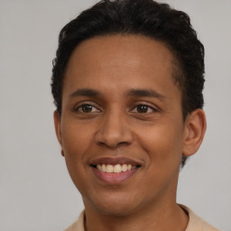 Joyful latino young-adult male with short  brown hair and brown eyes