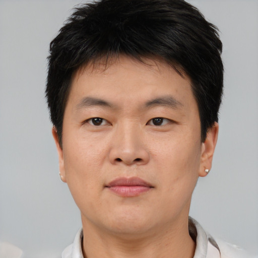 Neutral asian young-adult male with short  brown hair and brown eyes