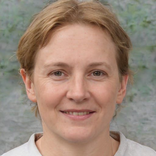 Joyful white adult female with short  brown hair and brown eyes