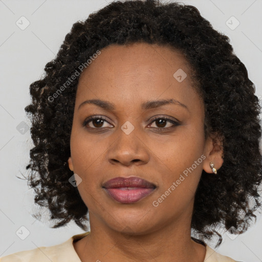 Joyful black adult female with medium  brown hair and brown eyes