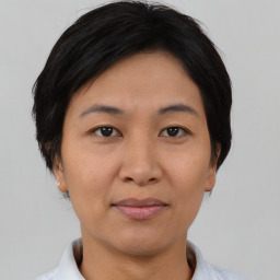 Joyful asian adult female with short  brown hair and brown eyes