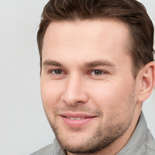 Joyful white young-adult male with short  brown hair and brown eyes