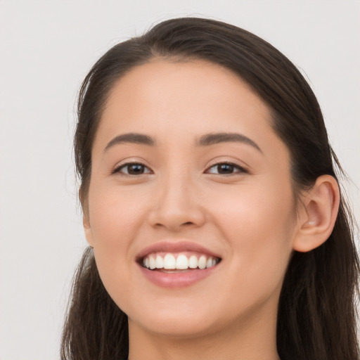 Joyful white young-adult female with long  brown hair and brown eyes