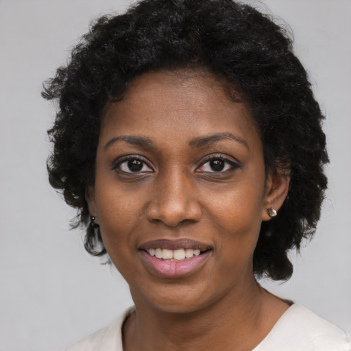 Joyful black young-adult female with medium  black hair and brown eyes