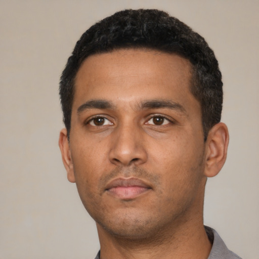 Neutral latino young-adult male with short  black hair and brown eyes