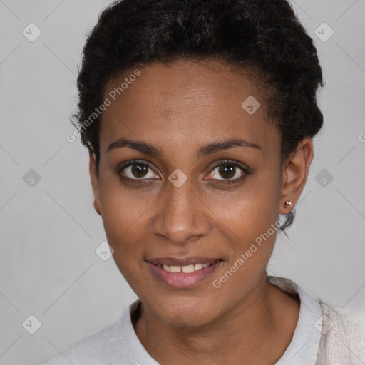 Joyful black young-adult female with short  black hair and brown eyes