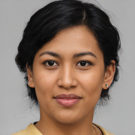 Joyful latino young-adult female with medium  black hair and brown eyes