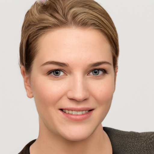 Joyful white young-adult female with short  brown hair and grey eyes