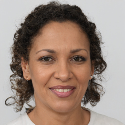 Joyful black adult female with medium  brown hair and brown eyes