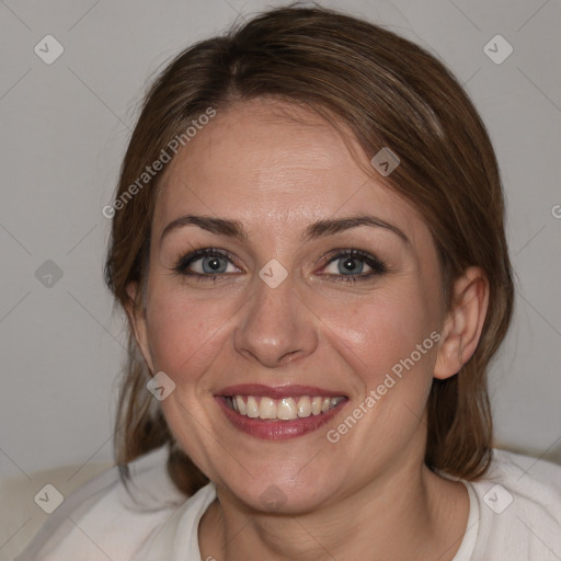 Joyful white adult female with medium  brown hair and blue eyes