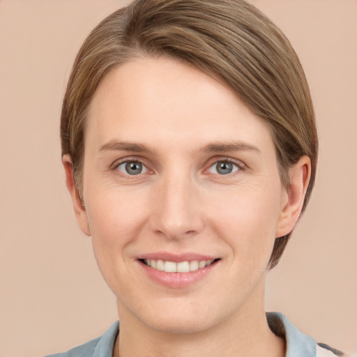 Joyful white young-adult female with short  brown hair and grey eyes