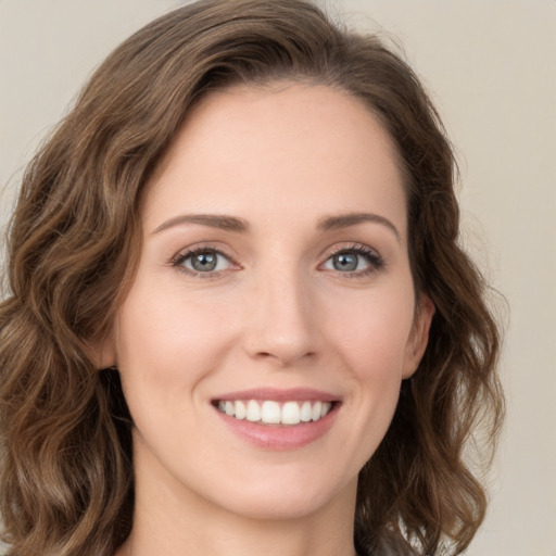 Joyful white young-adult female with medium  brown hair and green eyes