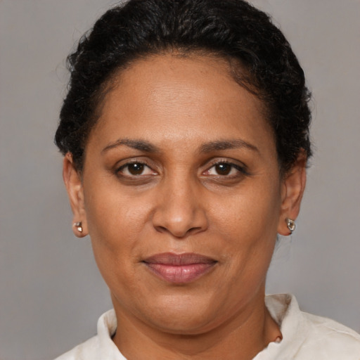 Joyful black adult female with short  brown hair and brown eyes
