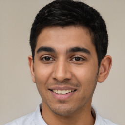 Joyful latino young-adult male with short  black hair and brown eyes