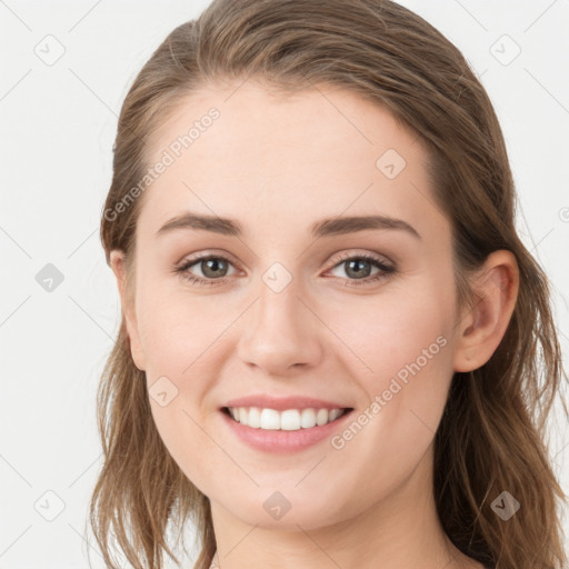 Joyful white young-adult female with long  brown hair and blue eyes