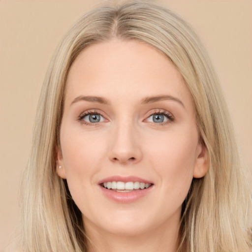 Joyful white young-adult female with long  brown hair and blue eyes