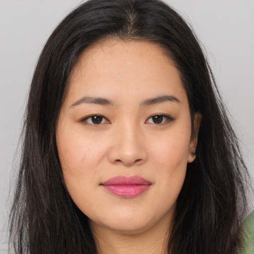 Joyful asian young-adult female with long  brown hair and brown eyes