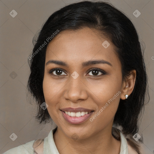 Joyful black young-adult female with medium  brown hair and brown eyes