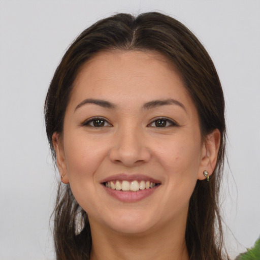 Joyful white young-adult female with long  brown hair and brown eyes