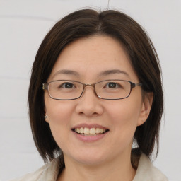 Joyful white adult female with medium  brown hair and brown eyes