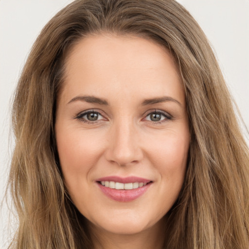 Joyful white young-adult female with long  brown hair and brown eyes