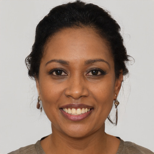 Joyful black young-adult female with short  brown hair and brown eyes