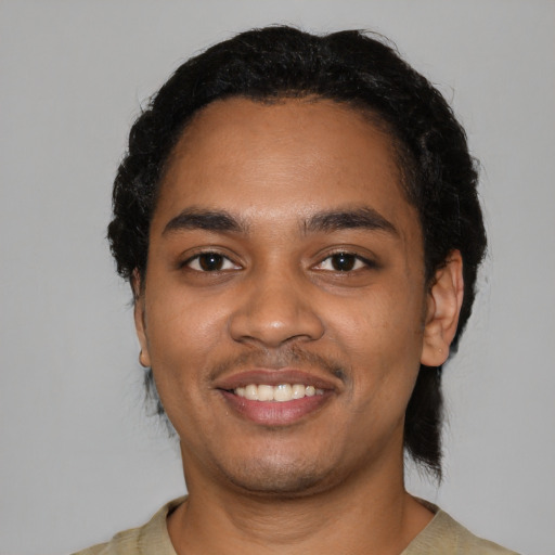 Joyful black young-adult male with short  black hair and brown eyes